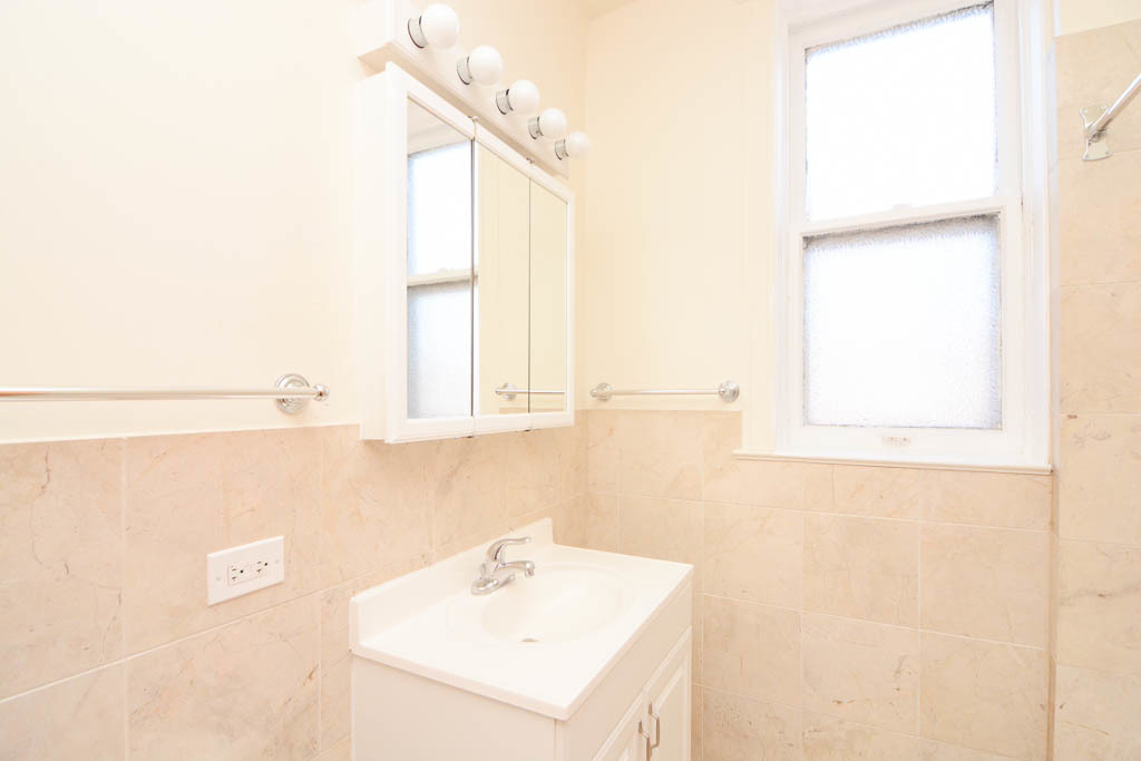 2225 West Walton Street, Unit 3 Chicago, IL 60622 - Photo 17 of 20 a bathroom with a sink a vanity and a window