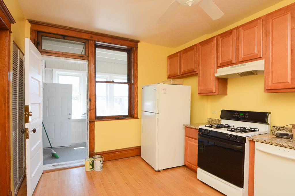 2225 West Walton Street, Unit 3 Chicago, IL 60622 - Photo 3 of 20 a kitchen with a refrigerator a stove a washer and dryer