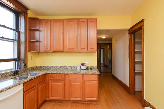 a kitchen with stainless steel appliances granite countertop wooden cabinets a sink and dishwasher