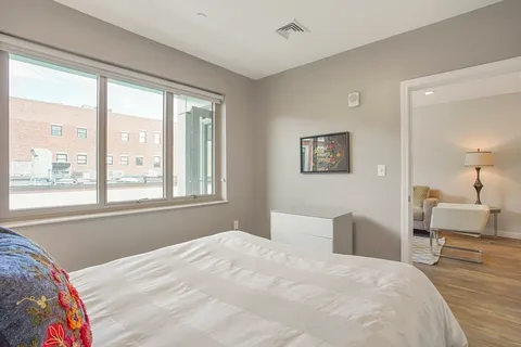 a bedroom with a large bed and a large window