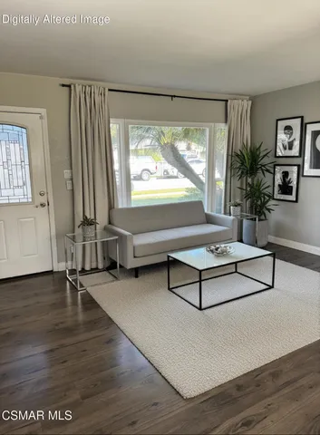 a living room with couch table and a large window