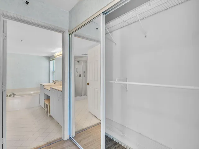 a spacious bathroom with a tub sink and mirror