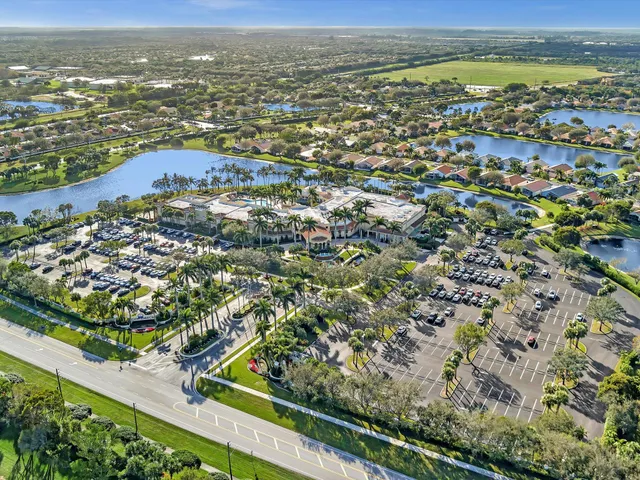 an aerial view of residential houses with outdoor space and trees