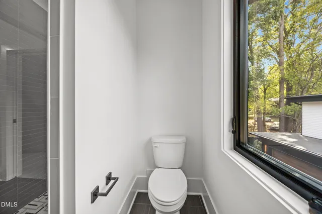 a view of a livingroom with a ceiling fan window and wooden floor