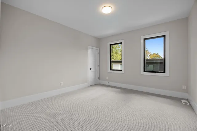 a front view of a house with a garden and sitting area
