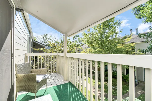 a view of a balcony with furniture