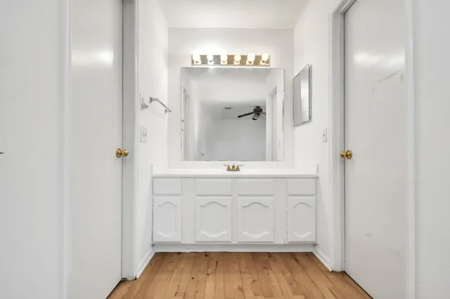 a bathroom with a glass door shower a sink and a mirror