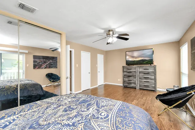 a bedroom with furniture and a flat screen tv