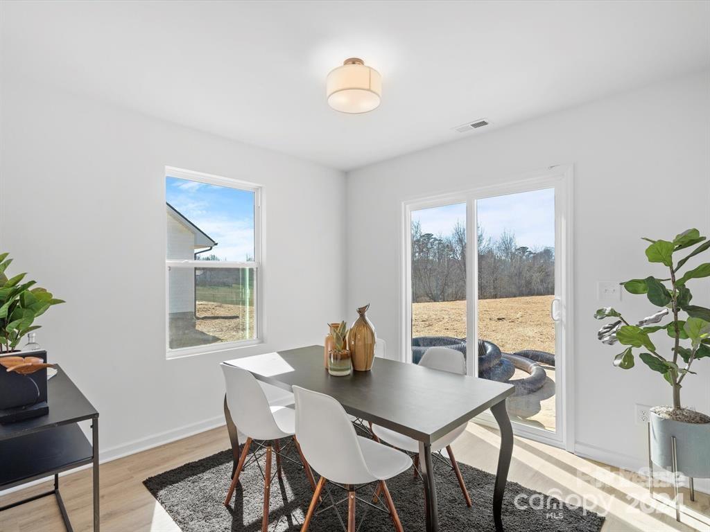 3799 Herman Sipe Road, Unit B Conover, NC 28613 - Photo 11 of 44 a view of a dining room with furniture window and wooden floor