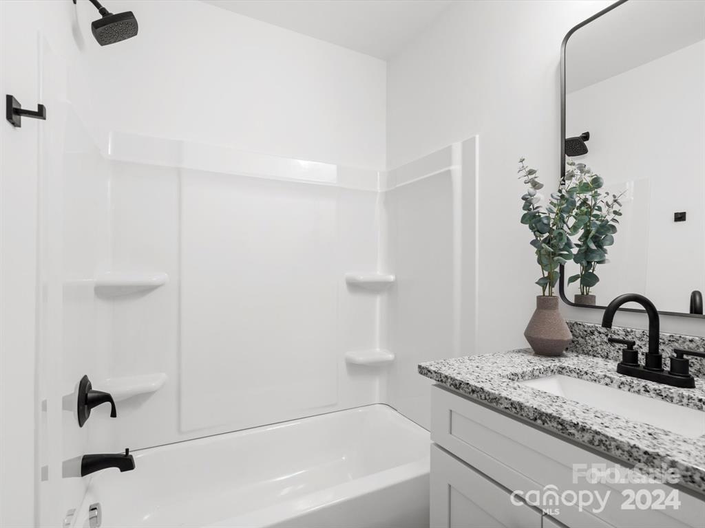 3799 Herman Sipe Road, Unit B Conover, NC 28613 - Photo 21 of 44 a bathroom with a granite countertop sink and a mirror