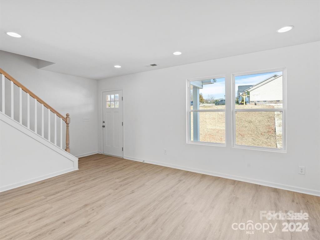 3799 Herman Sipe Road, Unit B Conover, NC 28613 - Photo 24 of 44 a view of an empty room with wooden floor and a window