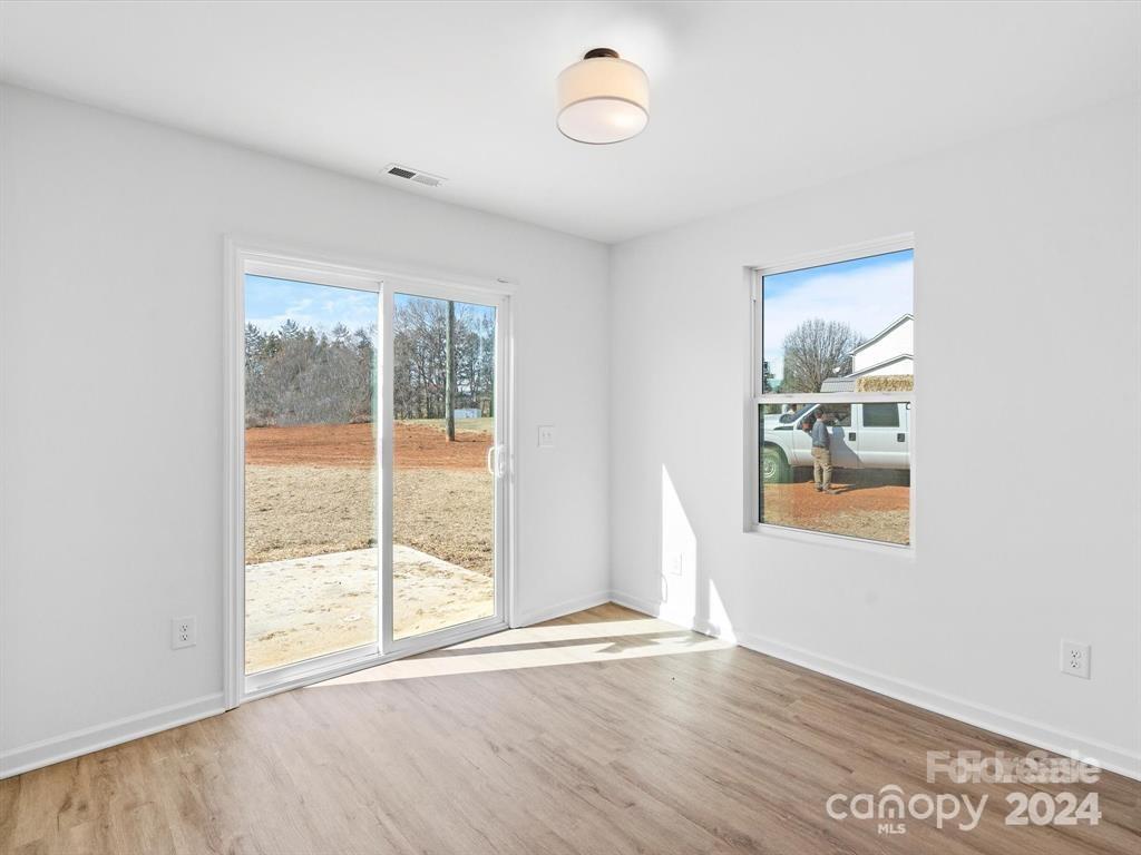 3799 Herman Sipe Road, Unit B Conover, NC 28613 - Photo 25 of 44 an empty room with wooden floor and windows