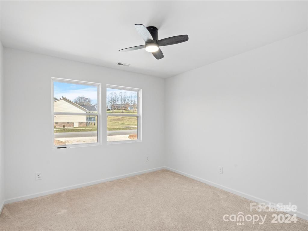 3799 Herman Sipe Road, Unit B Conover, NC 28613 - Photo 34 of 44 an empty room with ceiling fan and windows