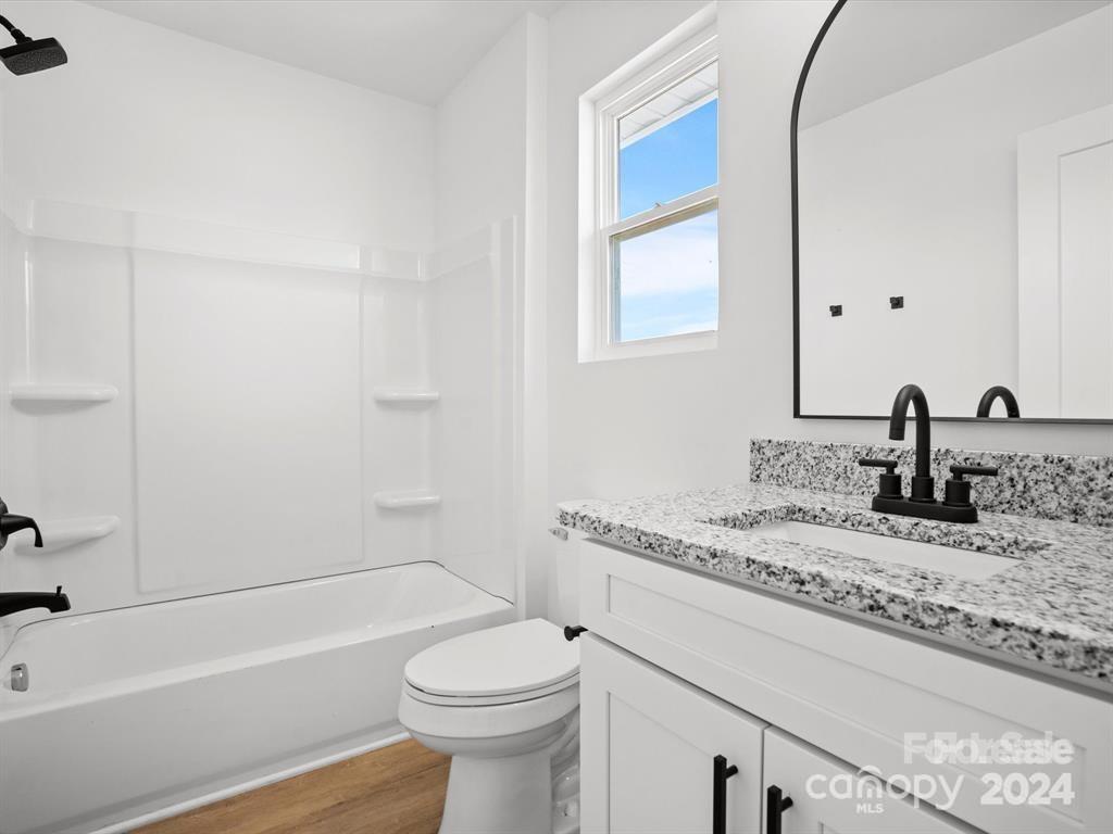 3799 Herman Sipe Road, Unit B Conover, NC 28613 - Photo 38 of 44 a bathroom with a granite countertop sink a toilet and bathtub