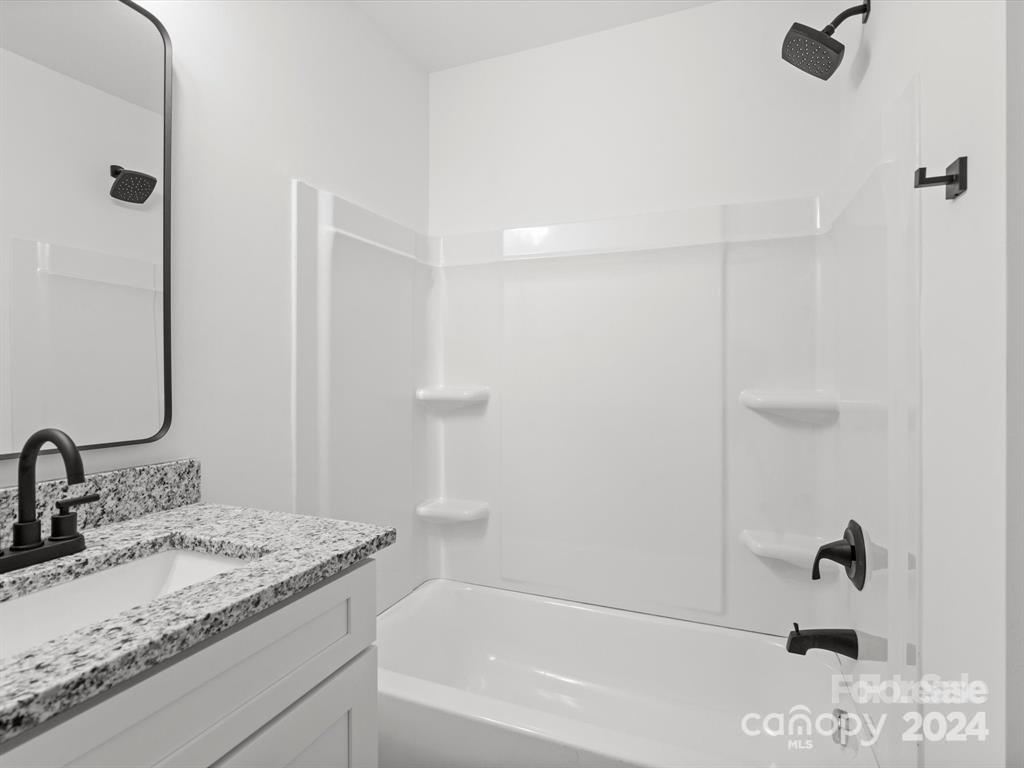 3799 Herman Sipe Road, Unit B Conover, NC 28613 - Photo 39 of 44 a bathroom with a granite countertop sink and a mirror