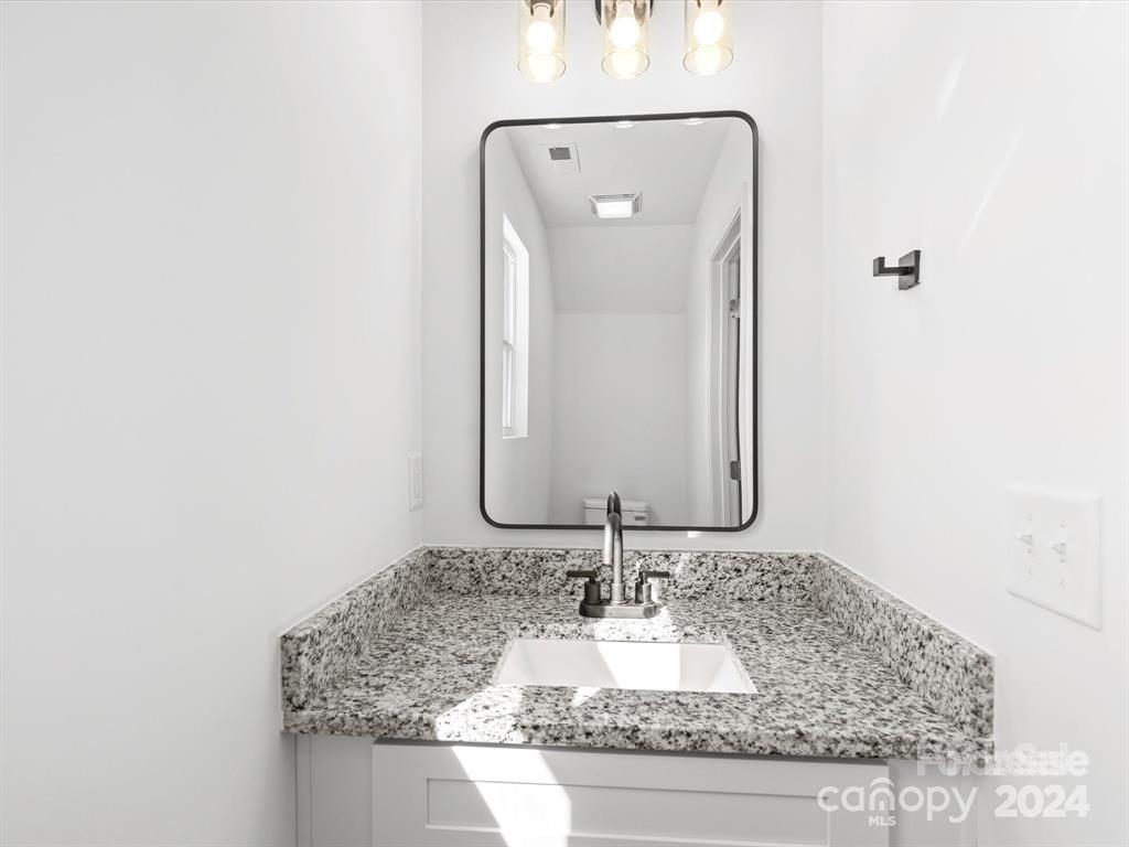 3799 Herman Sipe Road, Unit B Conover, NC 28613 - Photo 40 of 44 a bathroom with a granite countertop sink and a mirror