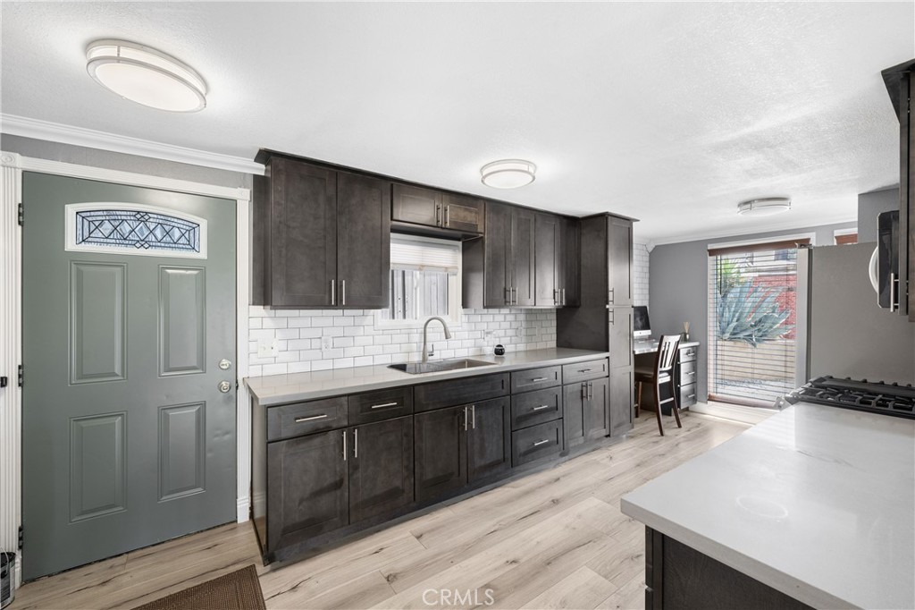 32857 Valley View Avenue Lake Elsinore, CA 92530 - Photo 2 of 12 a kitchen with lots of counter top space and painting on the wall