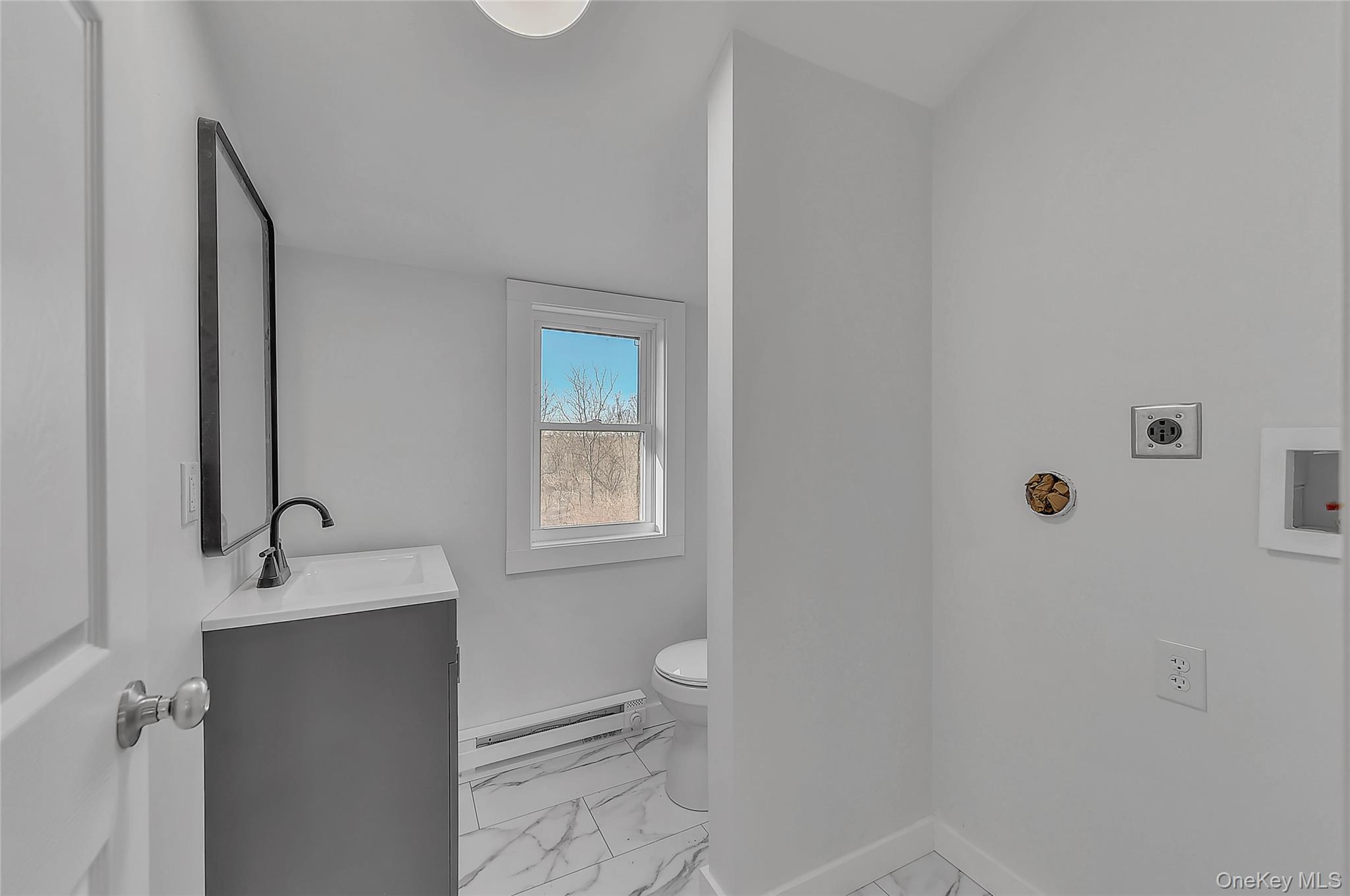 67 Jacobs Road Westtown, NY 10998 - Photo 21 of 36 Half bath featuring light marble finish floors, vanity, and a baseboard radiator