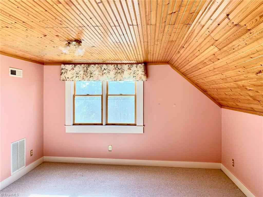 1876 Allred Road Lexington, NC 27292 - Photo 28 of 49 One of the 2nd floor bedrooms. There is a small stain on ceiling .This was from an old leak prior to 2019
