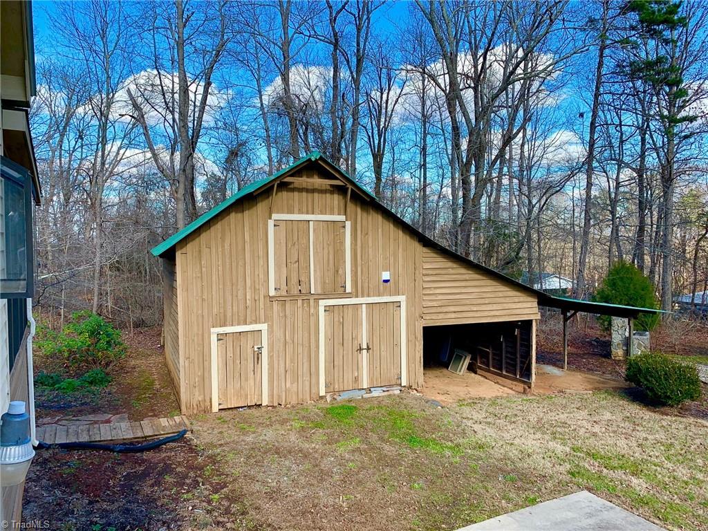 1876 Allred Road Lexington, NC 27292 - Photo 40 of 49 Wonderful old barn has two areas on main level inside and stairs to a loft area as well as the outdoor areas shown for parking vehicles, big-boy toys, etc. The lean to area would be so nice to finish for an outdoor gathering spot. Just need to add some flooring and twinkly string lights! It's near outdoor stone grill