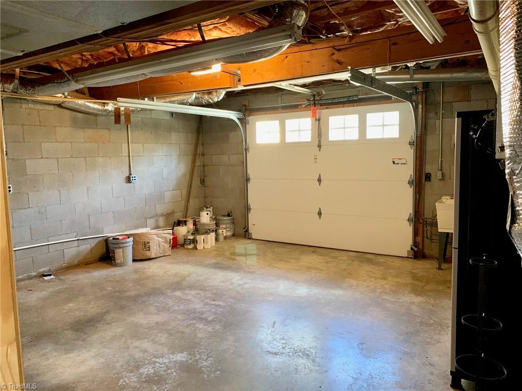 1876 Allred Road Lexington, NC 27292 - Photo 46 of 49 Basement garage...insulated garage door, large walk in crawl space off garage for GREAT storage, utility sink for washing up after yard time.