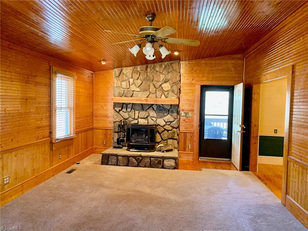 1876 Allred Road Lexington, NC 27292 - Photo 8 of 49 This gas log stove on stone hearth is in den...enter screen porch from door shown