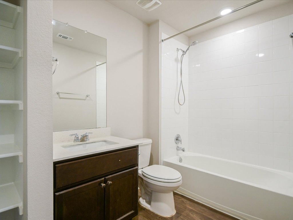 14408 Boquist Drive Pflugerville, TX 78660 - Photo 14 of 20 a bathroom with a sink a toilet and shower