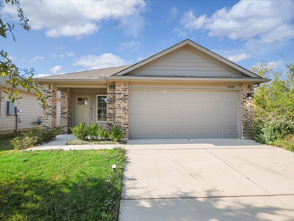 14408 Boquist Drive Pflugerville, TX 78660 - Photo 19 of 20 a front view of a house with a yard and garage