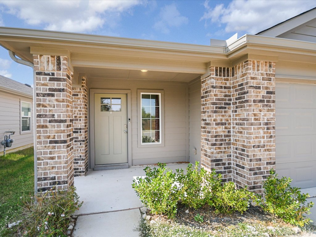 14408 Boquist Drive Pflugerville, TX 78660 - Photo 2 of 20 a view of front door of house with potted plants