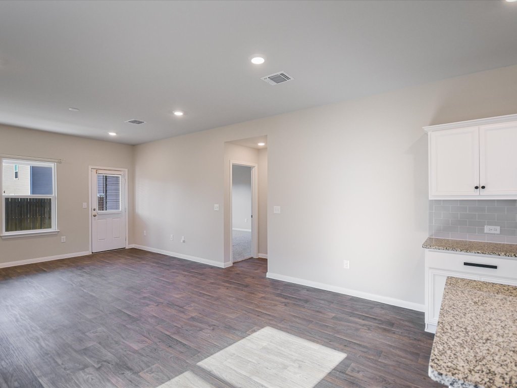 14408 Boquist Drive Pflugerville, TX 78660 - Photo 5 of 20 an empty room with wooden floor and windows
