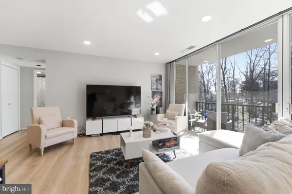 a bedroom with a bed and large windows