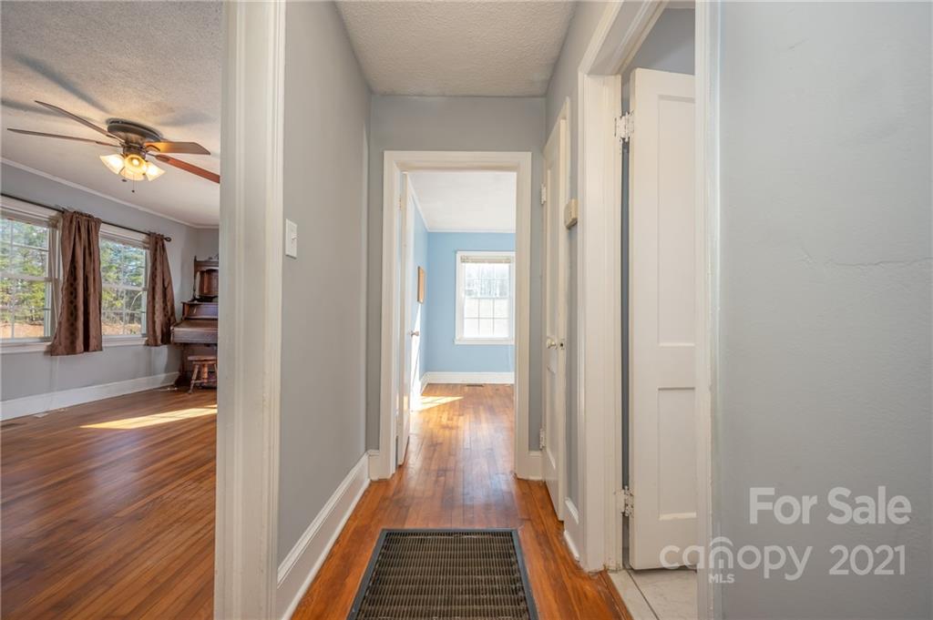 291 Cardinal Street Inman, SC 29349 - Photo 18 of 40 a view of a hallway with wooden floor and a living room
