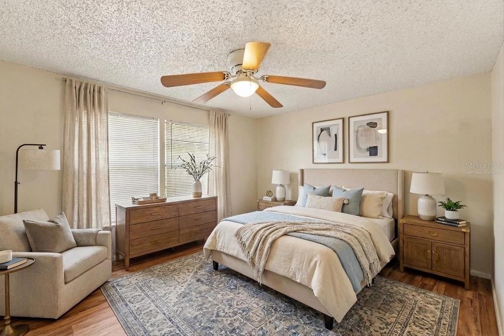 129 Camphor Circle, Unit F Oldsmar, FL 34677 - Photo 13 of 38 a bedroom with a large bed couch and a window