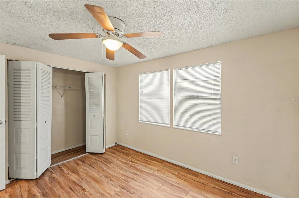 129 Camphor Circle, Unit F Oldsmar, FL 34677 - Photo 15 of 38 a view of an empty room with wooden floor and a window