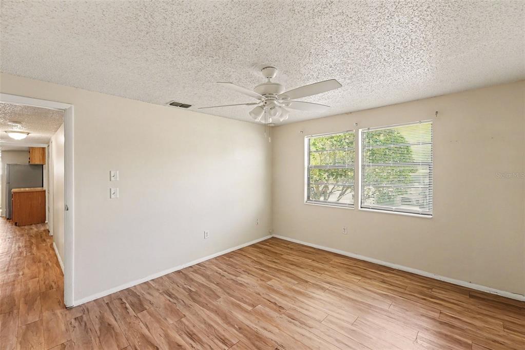 129 Camphor Circle, Unit F Oldsmar, FL 34677 - Photo 21 of 38 a view of an empty room with wooden floor and a window