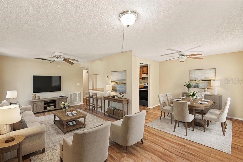 129 Camphor Circle, Unit F Oldsmar, FL 34677 - Photo 5 of 38 a living room with furniture a flat screen tv and a table