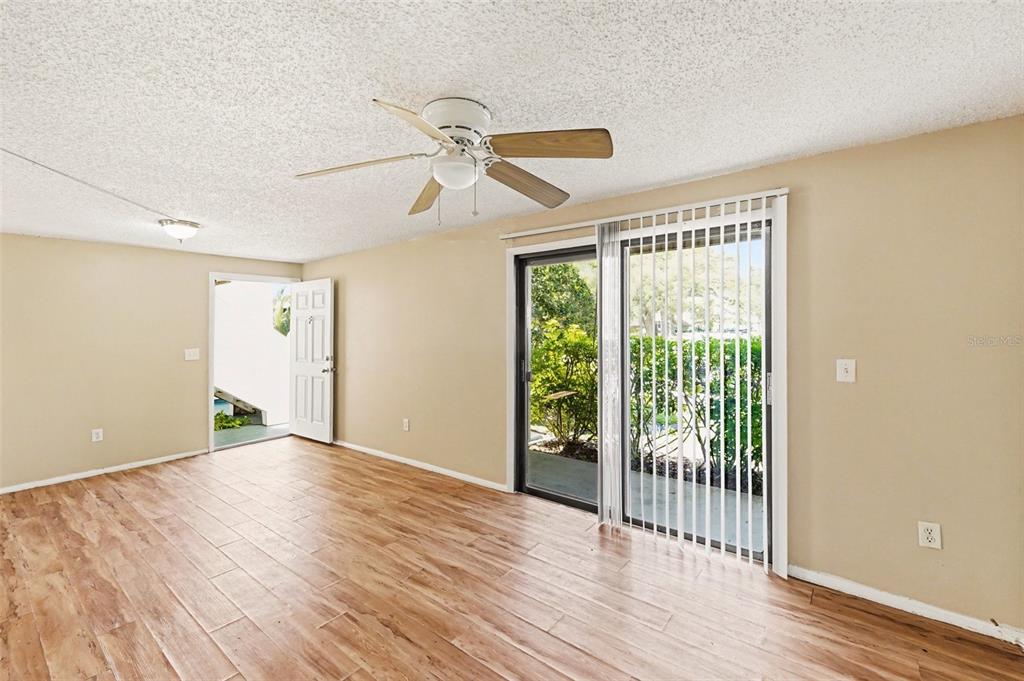 129 Camphor Circle, Unit F Oldsmar, FL 34677 - Photo 9 of 38 a view of empty room with wooden floor and fan