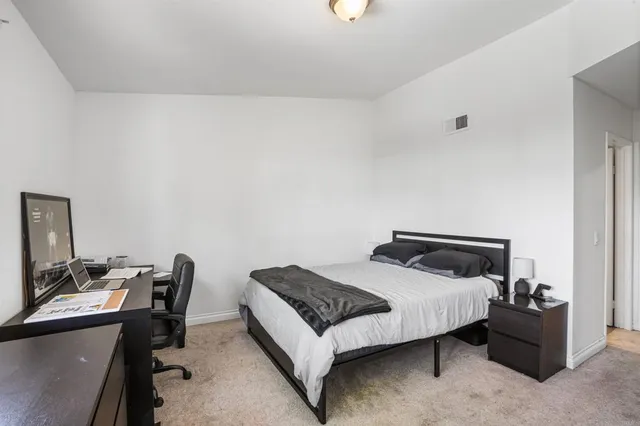 a bedroom with a bed and a desk