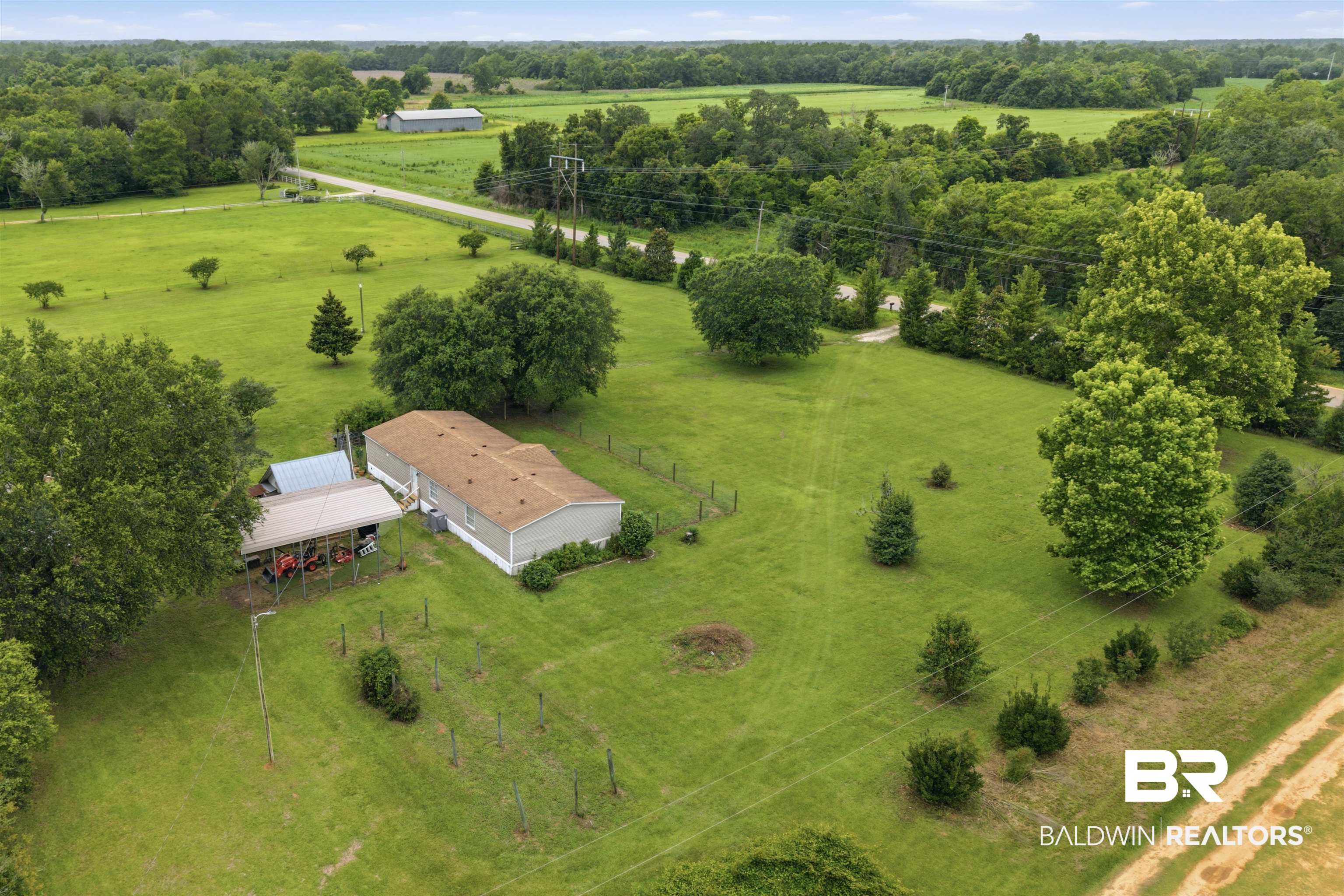 26788 Feely Road Elberta, AL 36530 - Photo 26 of 31 Expansive green landscape with a single-story residence and detached carport