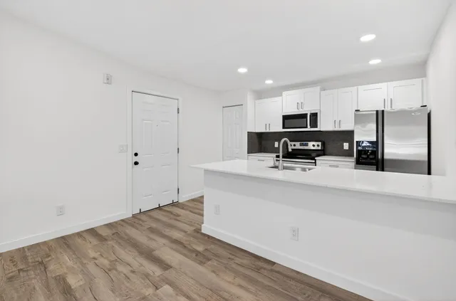 a view of kitchen with wooden floor