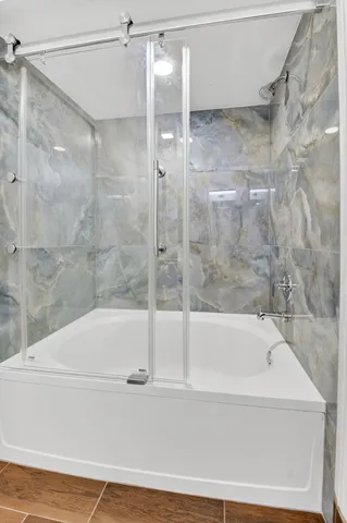 a bathroom with a bathtub and a shower