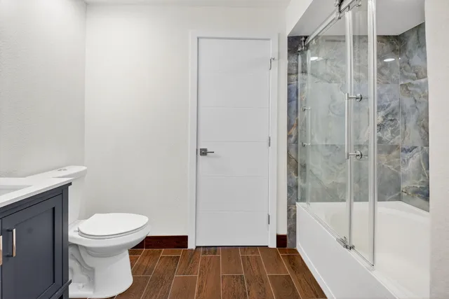 a bathroom with a toilet and a shower