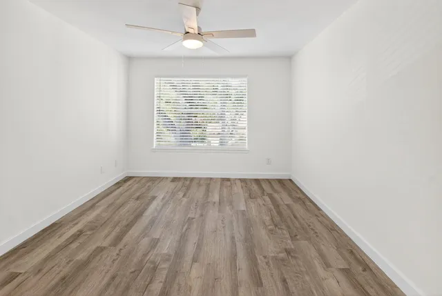 wooden floor in an empty room with a window