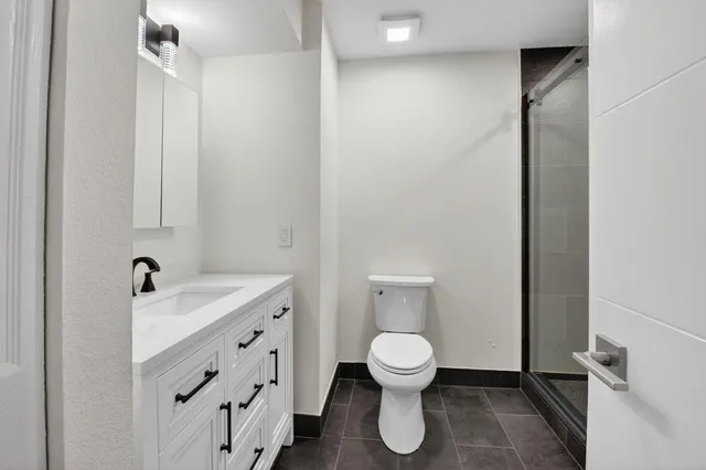 a white toilet sitting next to a bathroom sink