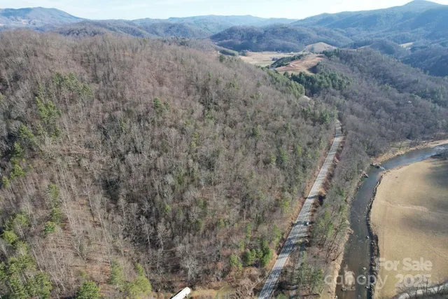 a view of a dry yard with mountains in the background