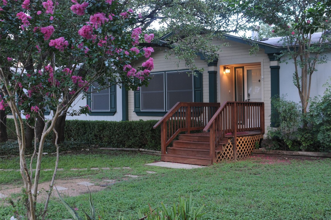 a view of a chair and table in the yard with wooden fence
