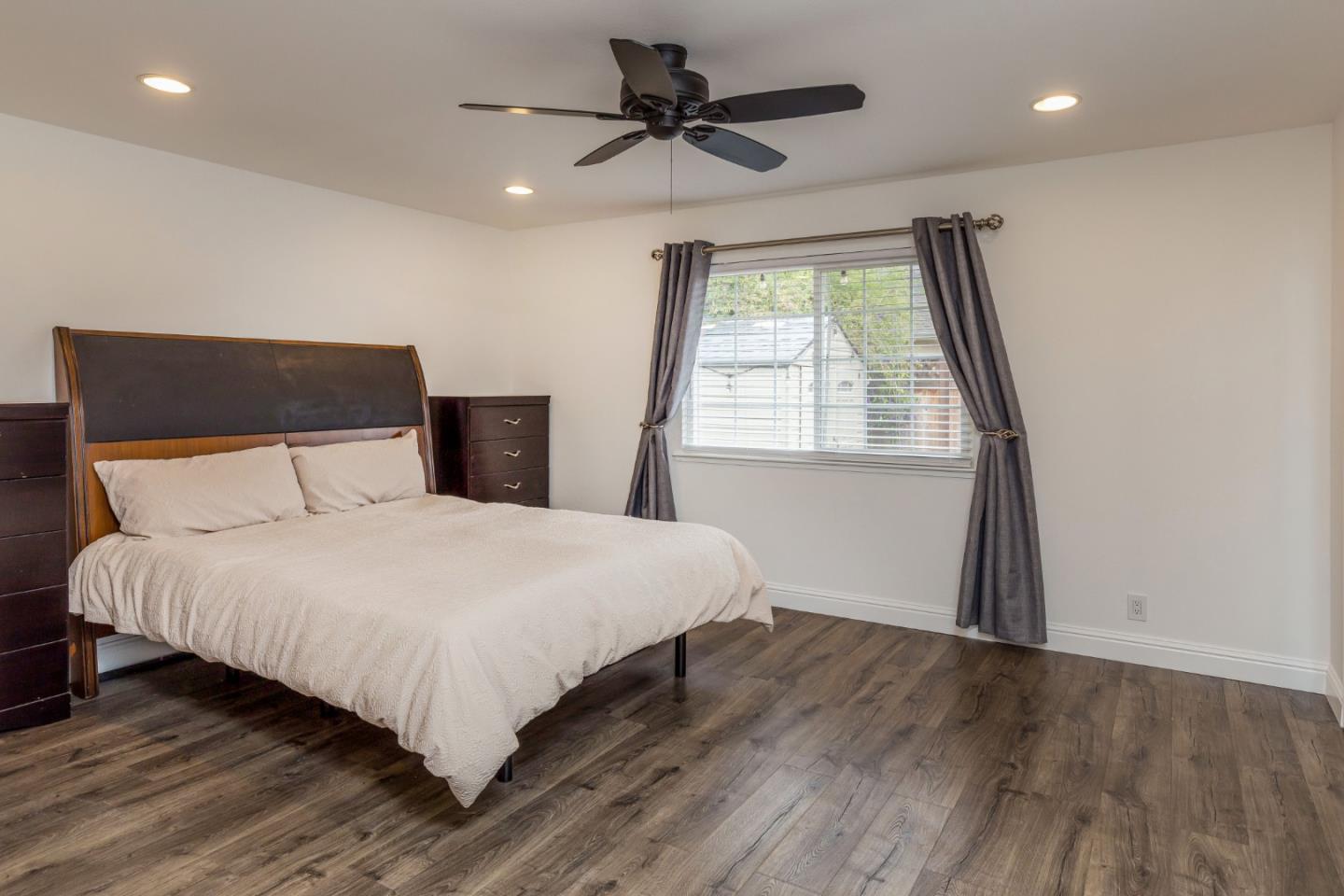 843 Ramona Way Gilroy, CA 95020 - Photo 13 of 26 a bedroom with a bed and a chandelier