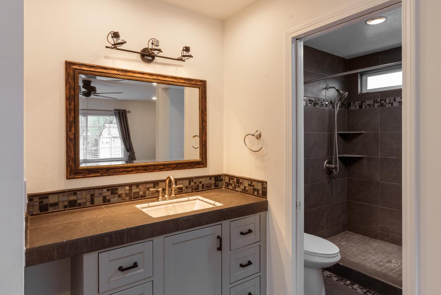 843 Ramona Way Gilroy, CA 95020 - Photo 15 of 26 a bathroom with a sink and a mirror