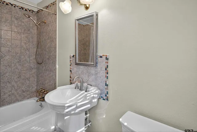 a bathroom with a bathtub and a shower