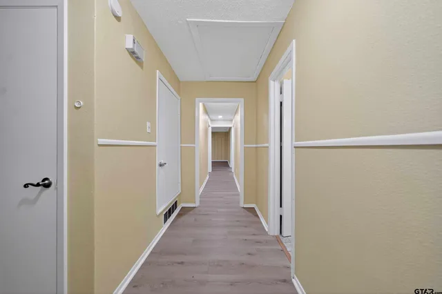 a view of a room with wooden floor and bench